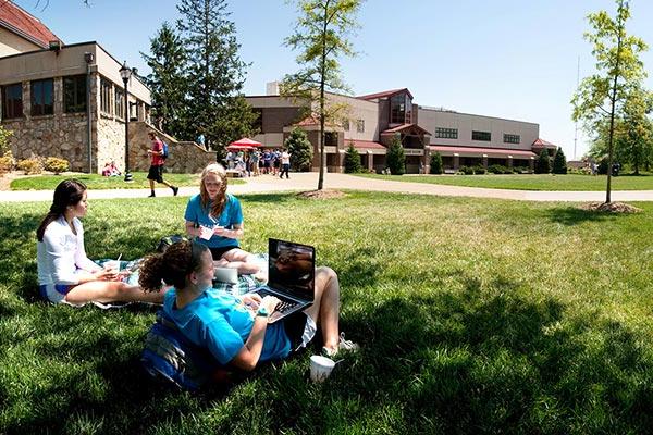 students on lawn in front of mills hall