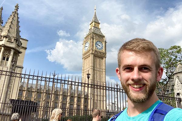 student with clock tower in the background